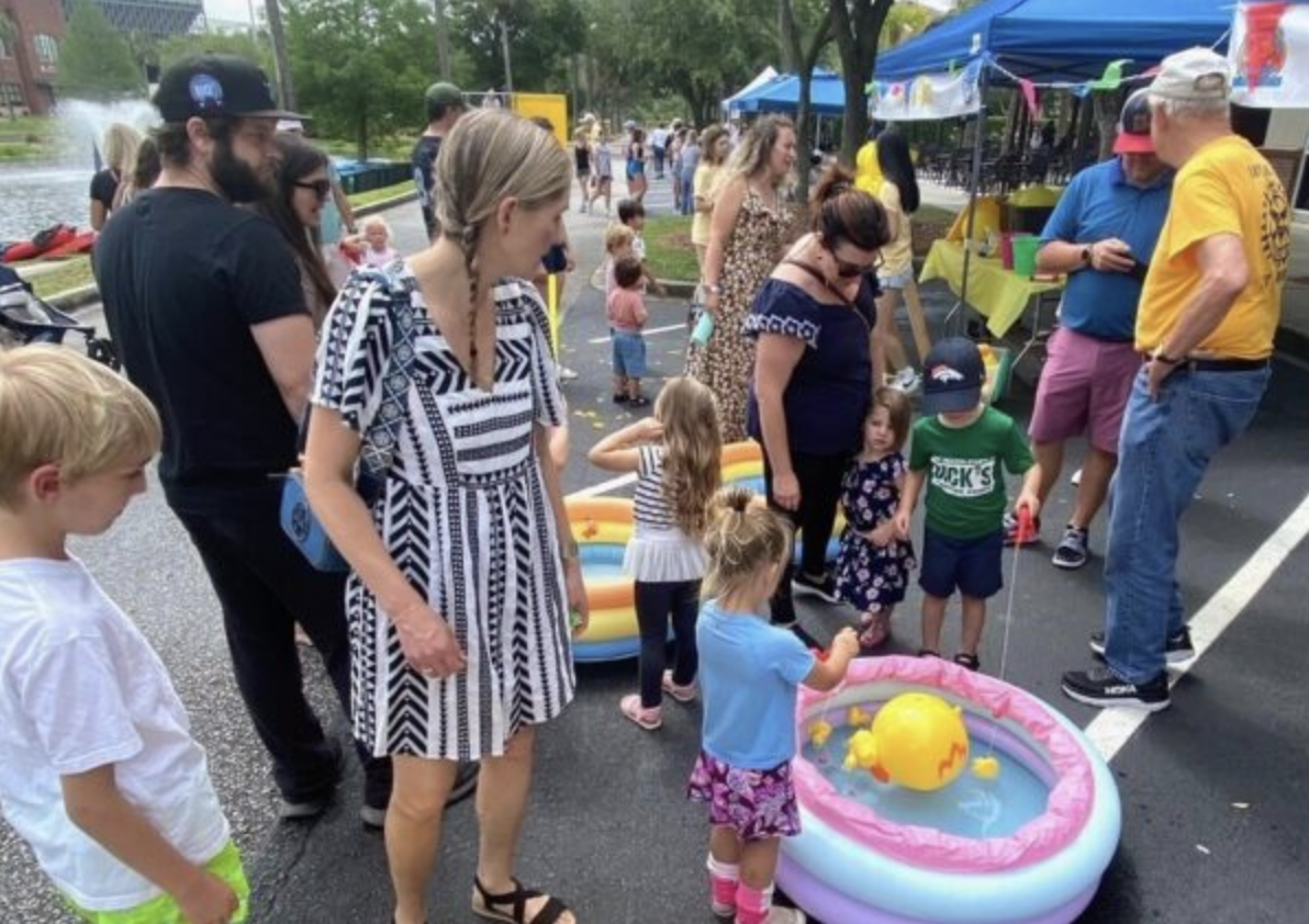 Families playing a duck game at the Charleston Charity Duck Race festival